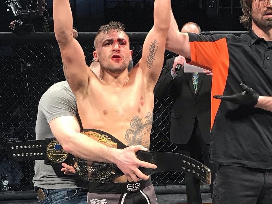 Victor Rodriguez with the AFC bantamweight title belt