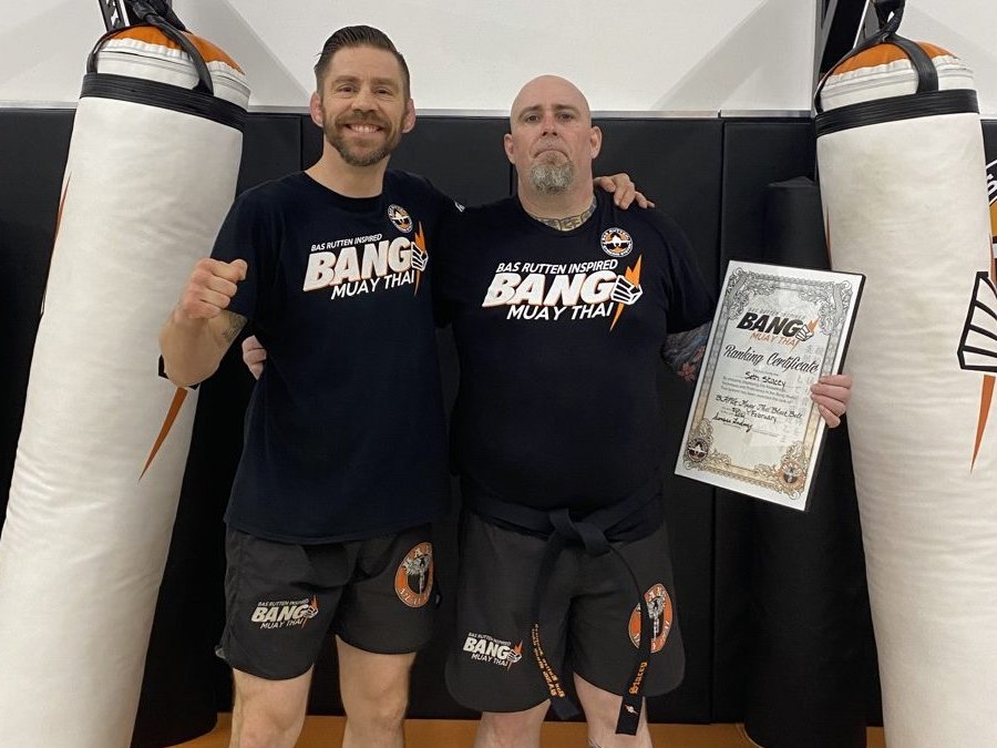 Coach Seth Stacey receiving his black belt from Duane Ludwig