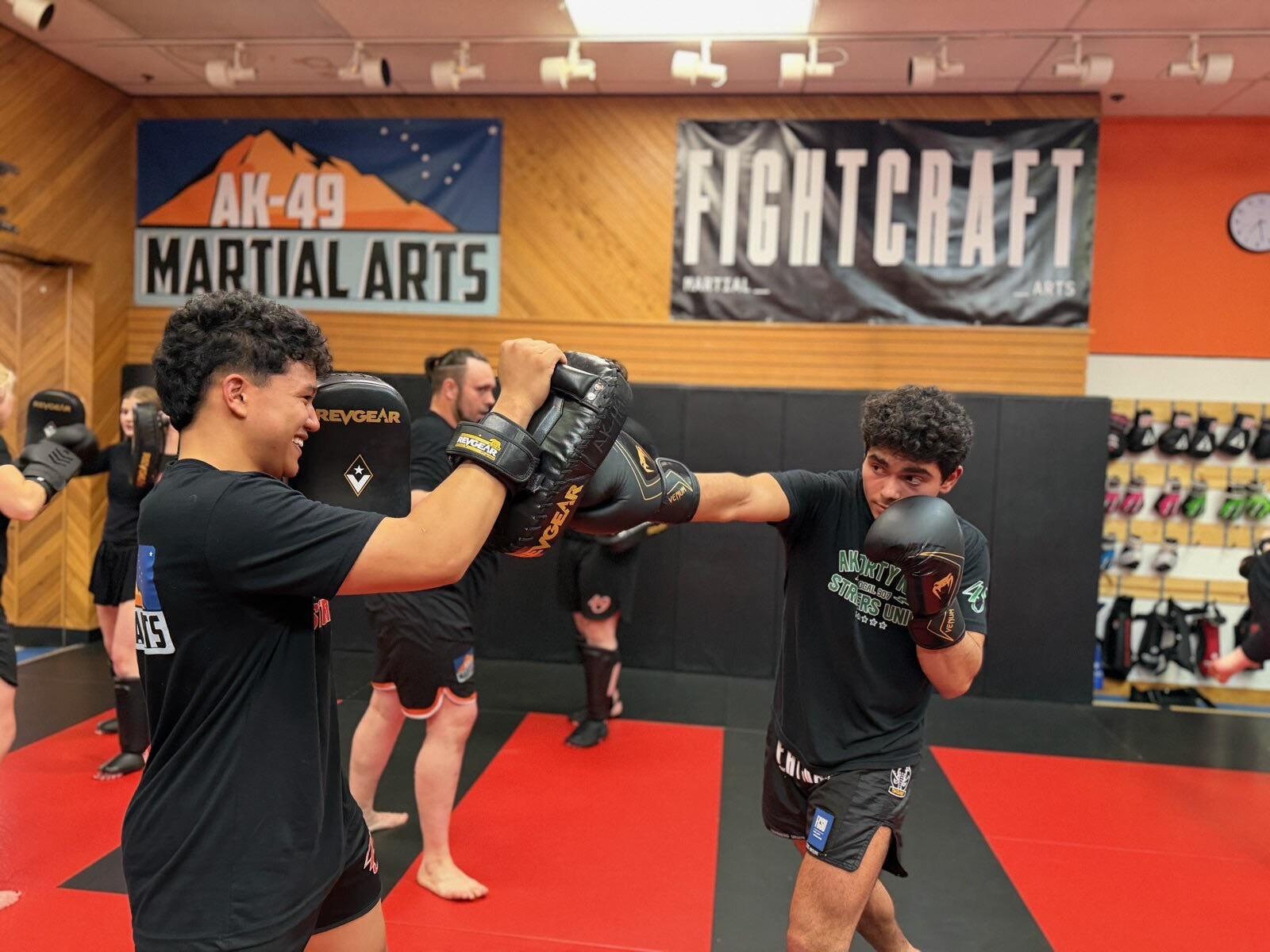 Two students doing controlled partner pad work at AK-49 Martial Arts